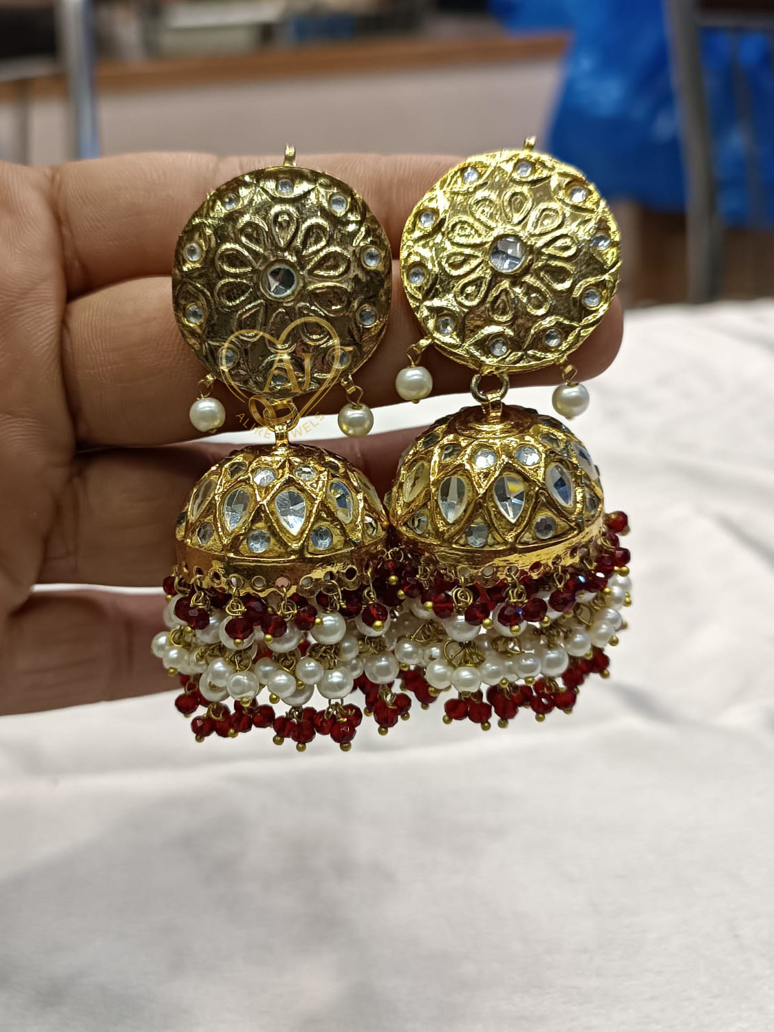 24 karat gold plated Kundan Jhumka Earrings ALIRE JEWELS 24K Gold Plated Kundan Jhumka Earrings with pearls and red beads.