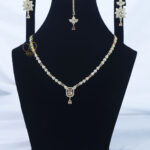 ALIRE JEWELS Golden Champagne Rectangular Stone Necklace Set with gold plating, matching earrings and maang tikka