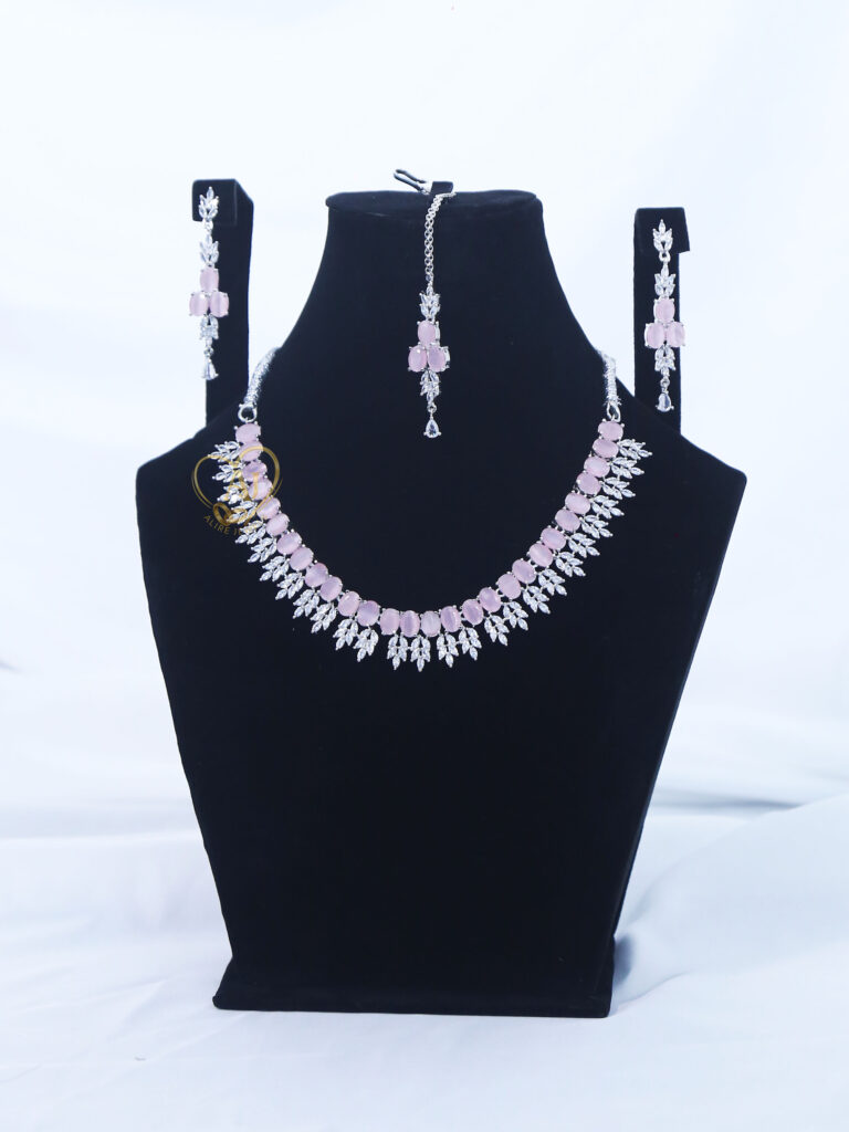 ALIRE JEWELS Pink Stone Necklace Set with silver plated detailing, matching earrings and maang tikka