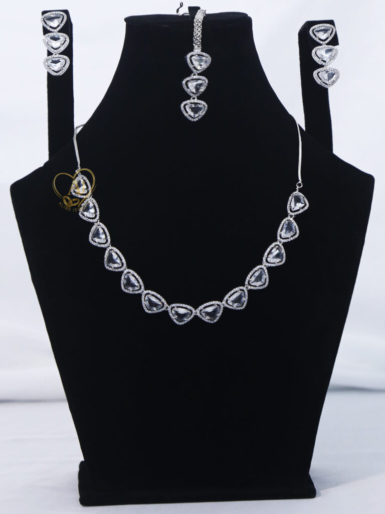 ALIRE JEWELS Heart Shaped White Crystal Necklace Set with silver plating, matching earrings and maang tikka