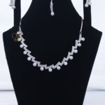 ALIRE JEWELS Modern White Crystal Necklace Set with silver plating, matching earrings and maang tikka