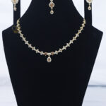 ALIRE JEWELS Golden Champagne Stone Necklace Set with gold plated chain, matching earrings and maang tikka