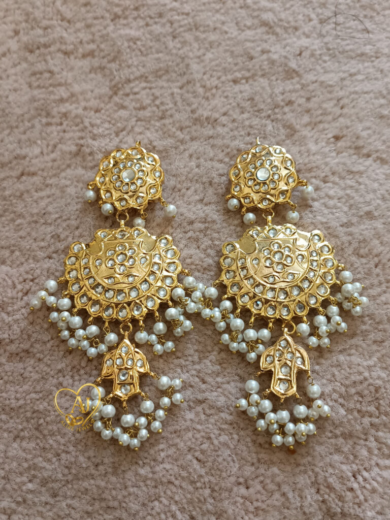 Heritage Charm Kundan Earrings – 24K Gold Plated with Pearl Clusters Luxury kundan long earrings with floral top, crescent base, and charm drop Traditional bridal kundan earrings with anti-tarnish guarantee